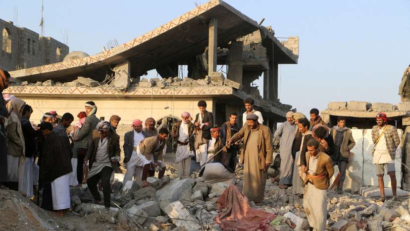 FILE PHOTO: People gather on the rubble of a house hit by a U.S. strike in Saada