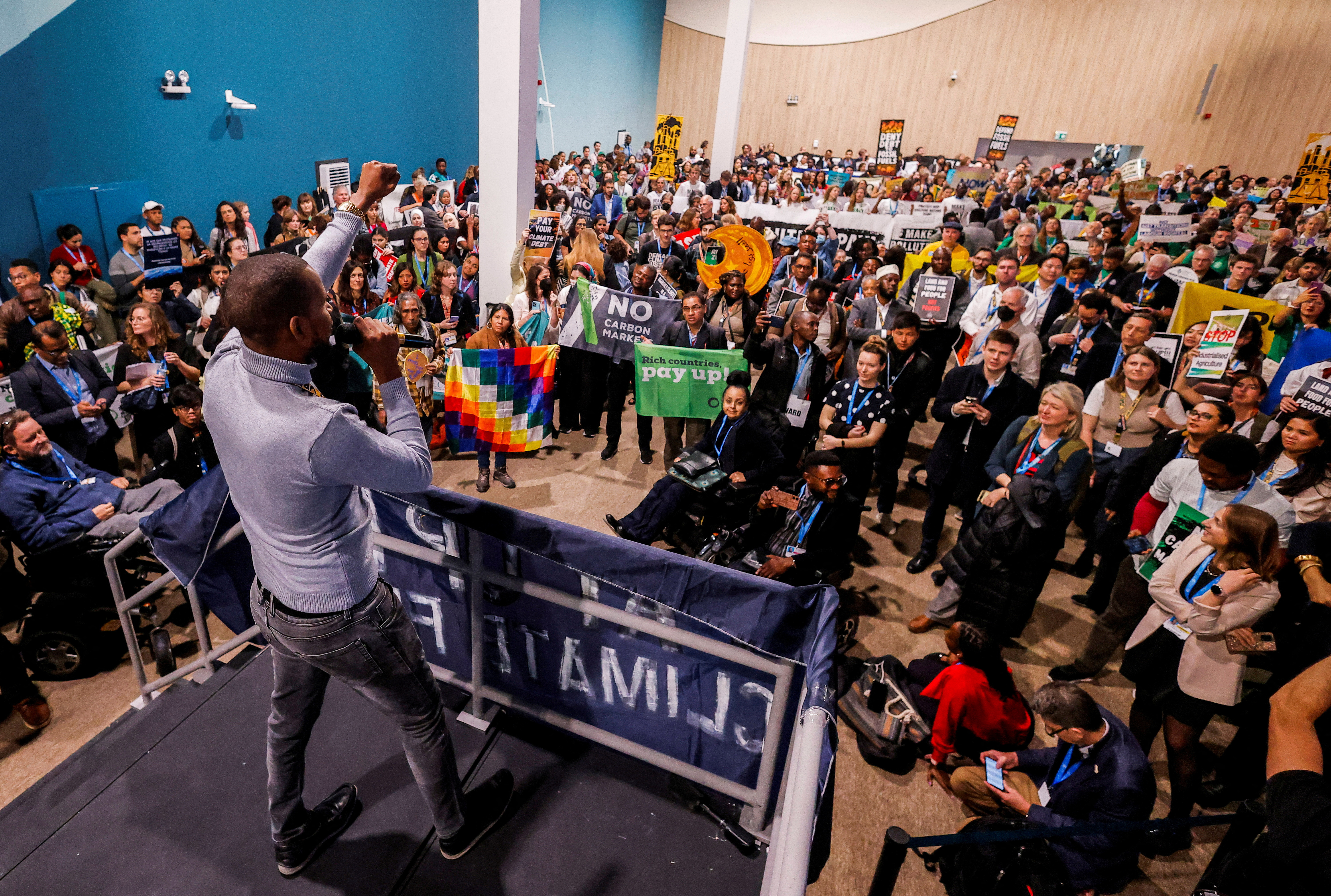 Activists protest to urge world leaders to commit to a strong climate finance deal during COP29, in Baku