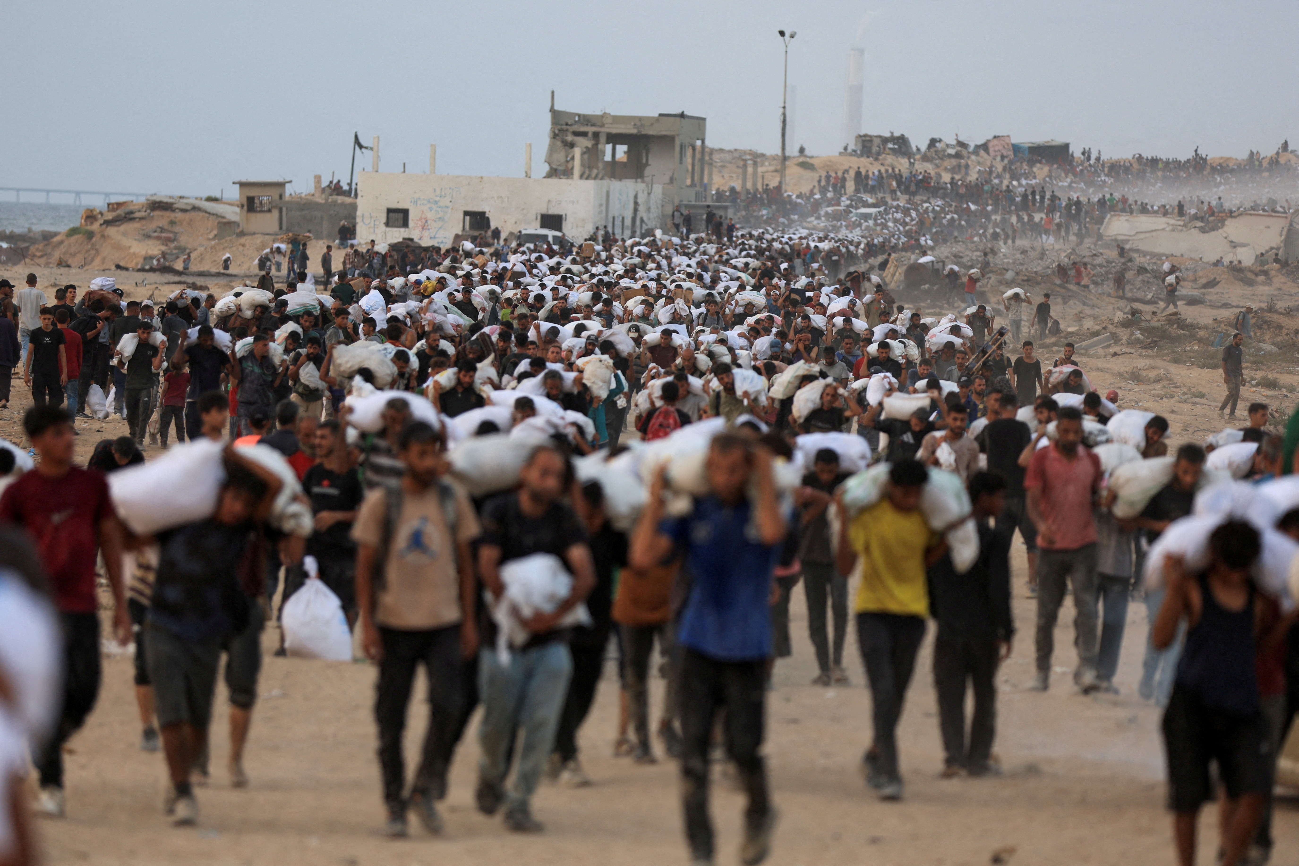 FILE PHOTO: Palestinians receive aid supplies in Beit Lahia