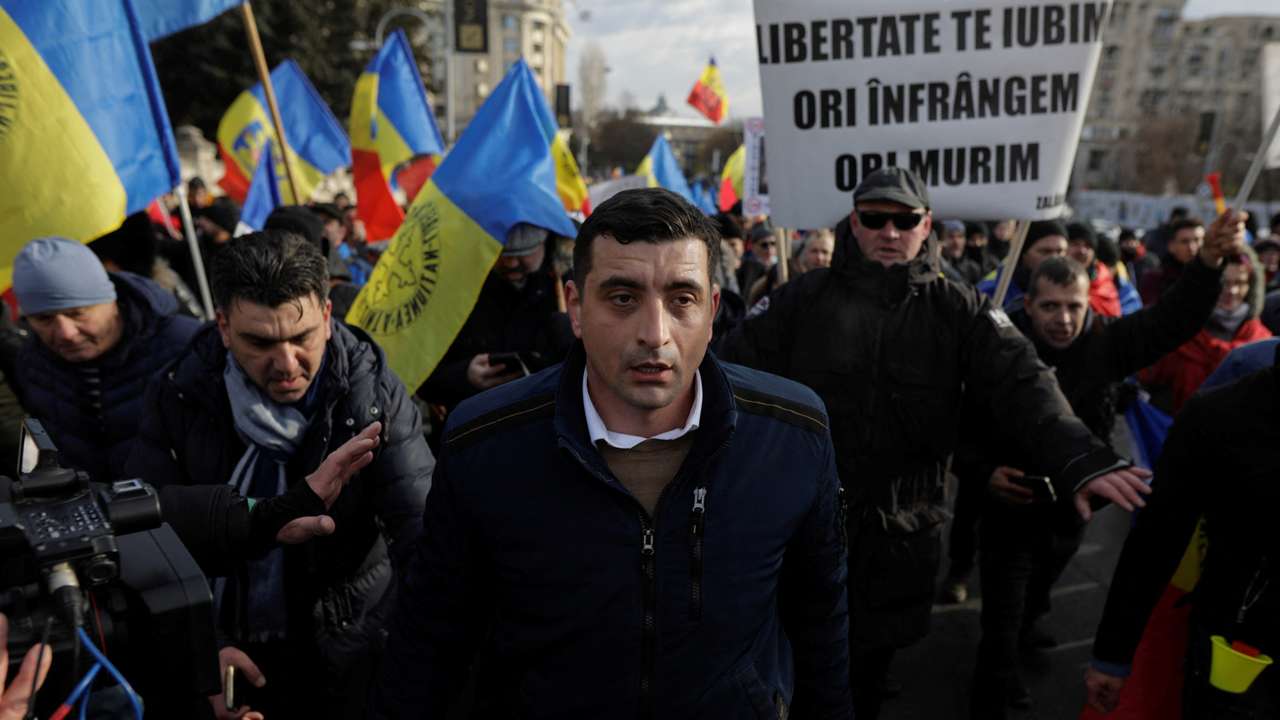 People attend protest against the introduction of COVID passes