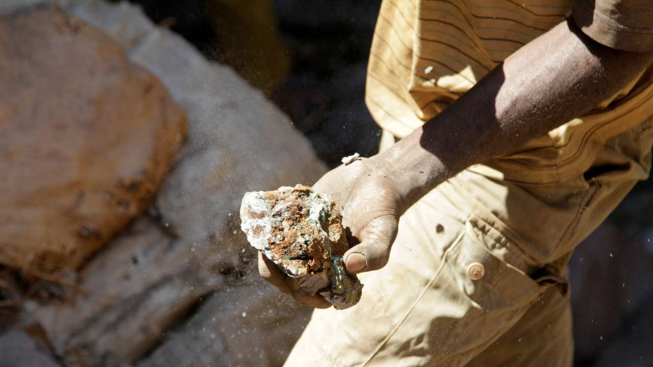 An artisanal miner carries raw ore at Tilwizembe outside of Kolwezi
