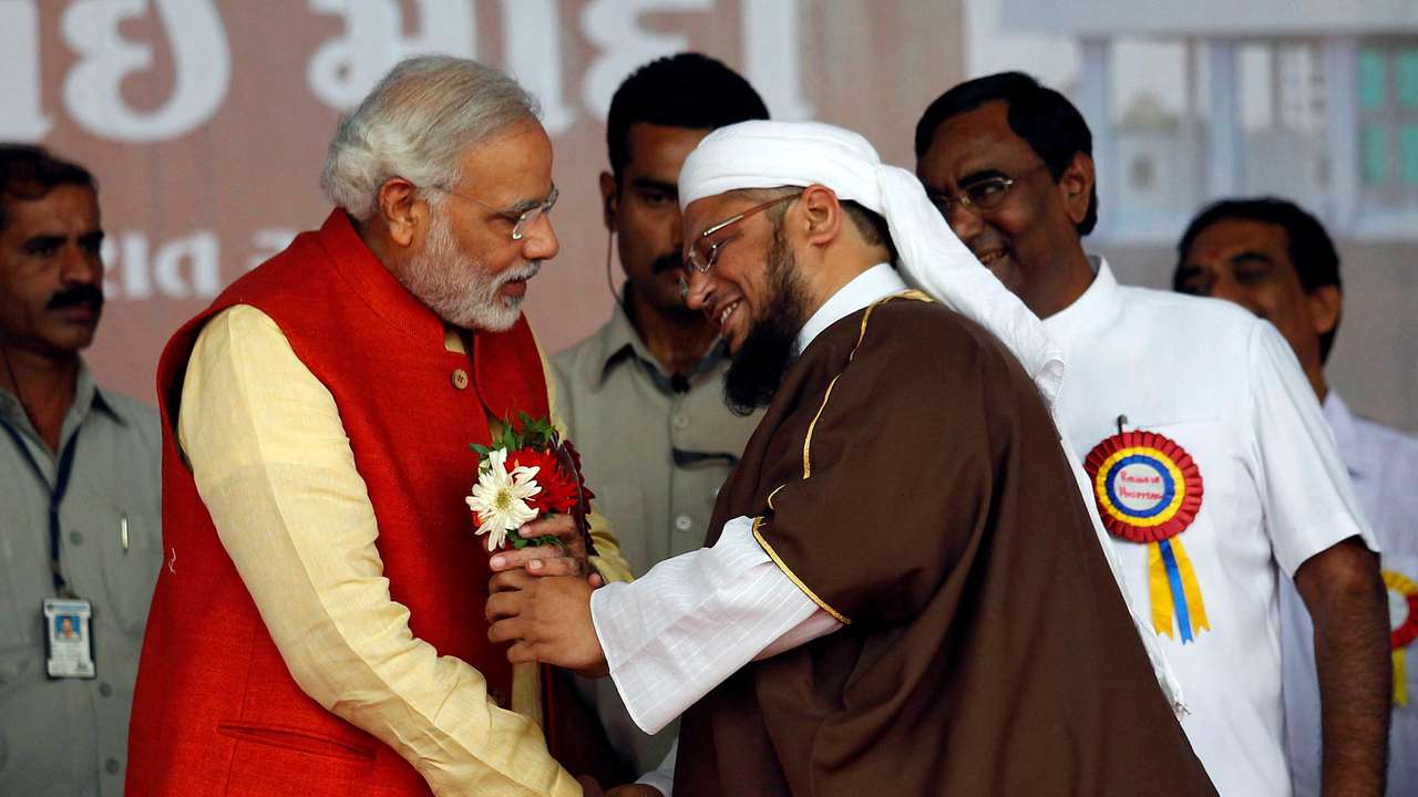 FILE PHOTO: Narendra Modi receives flowers from a Muslim cleric after inauguration of a hospital in Balasinore