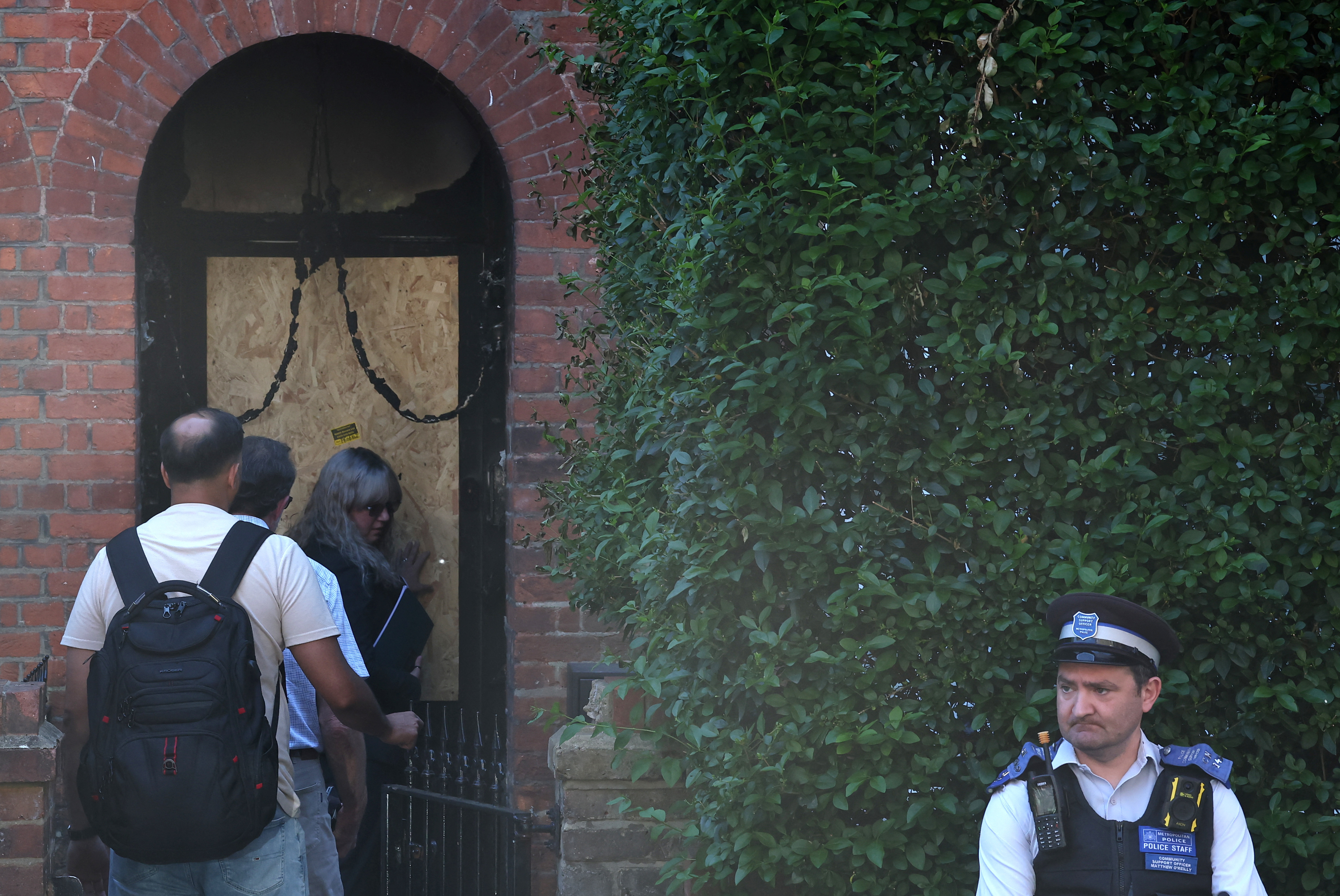Police officers stand outside Britain's Prime Minister Starmer's home, after it was damaged by fire in suspected arson attack in north London