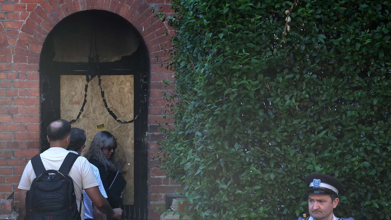 Police officers stand outside Britain's Prime Minister Starmer's home, after it was damaged by fire in suspected arson attack in north London