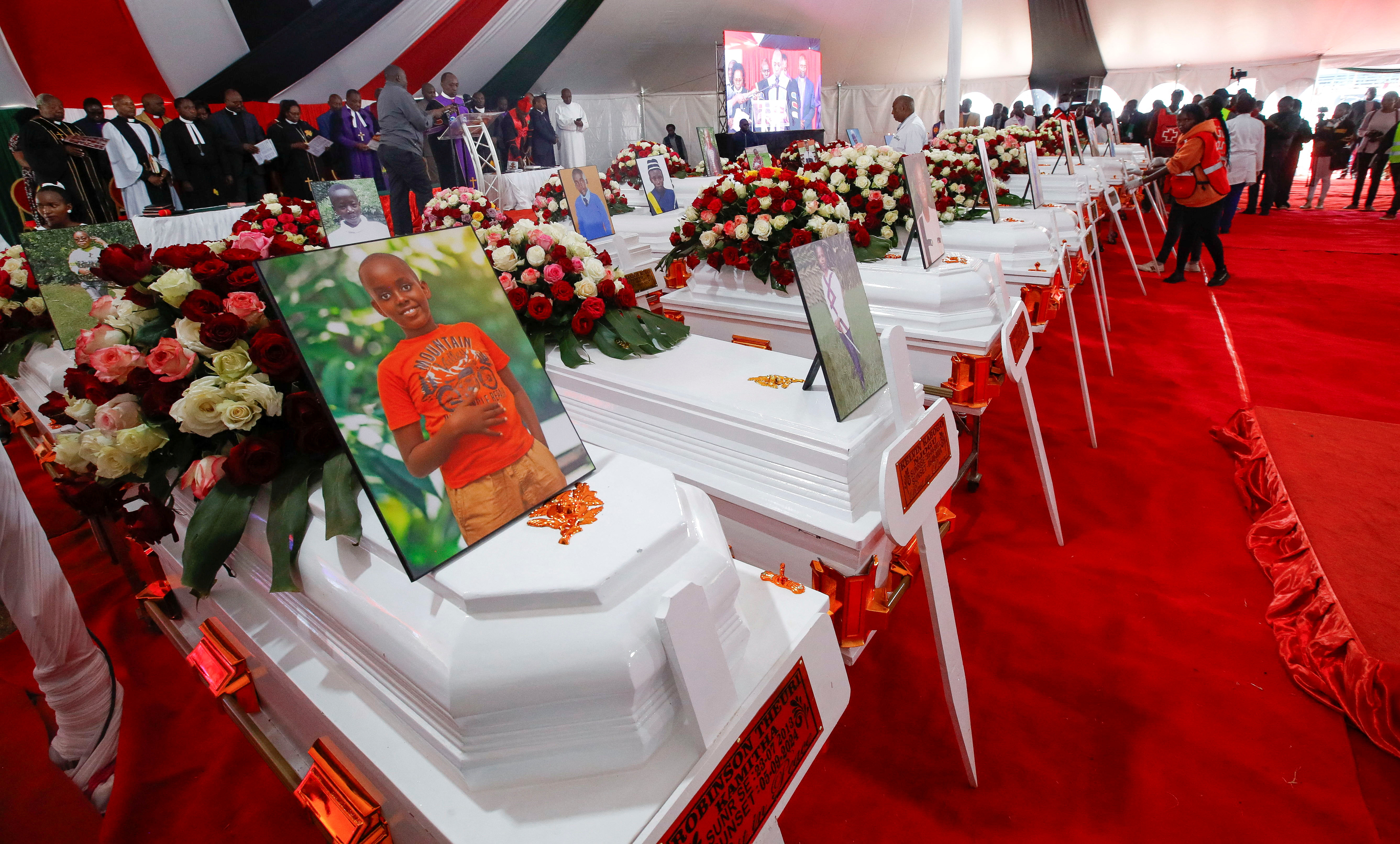 Coffins are arranged before a memorial service for the pupils who died after a fatal fire at the Hillside Endarasha Academy within Kieni in Nyeri County