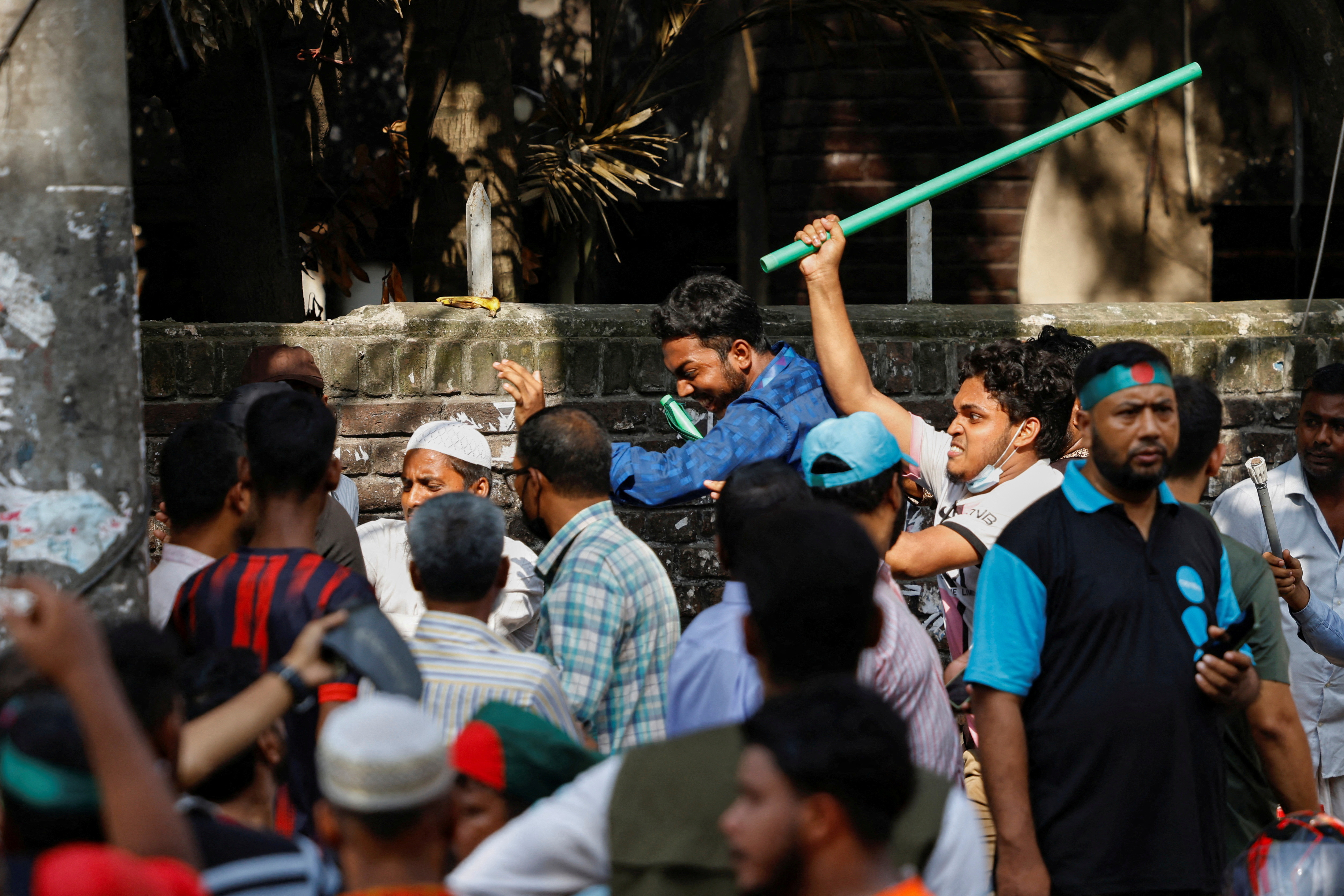 Protesters beat a suspected Awami League supporter in front of Bangabandhu Sheikh Mujibur Rahman Memorial Museum in Dhaka
