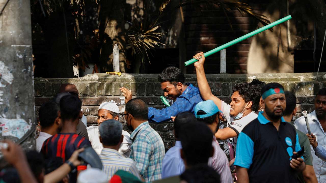 Protesters beat a suspected Awami League supporter in front of Bangabandhu Sheikh Mujibur Rahman Memorial Museum in Dhaka