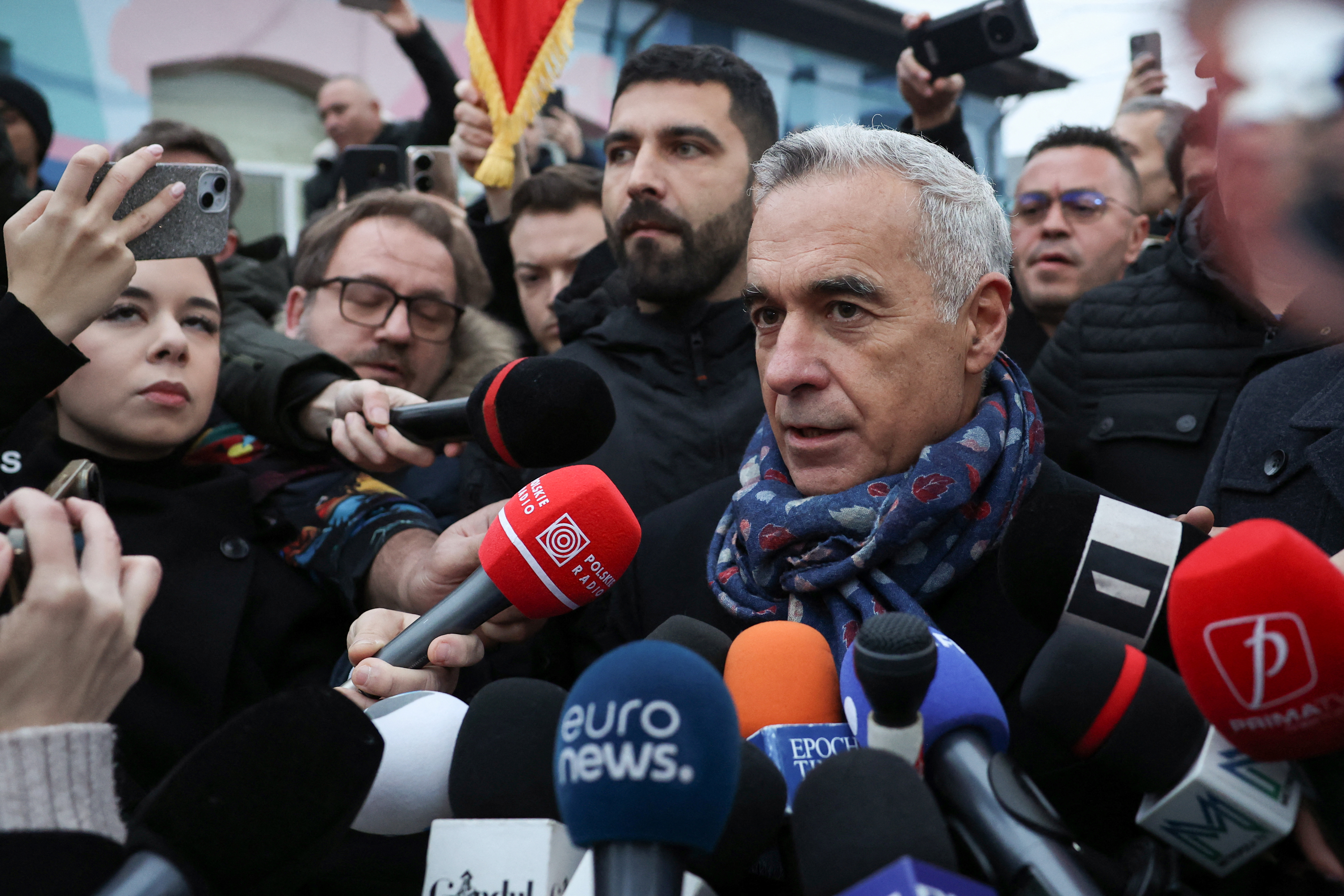 Romanian independent far-right presidential candidate Calin Georgescu gives a statement outside his voting station