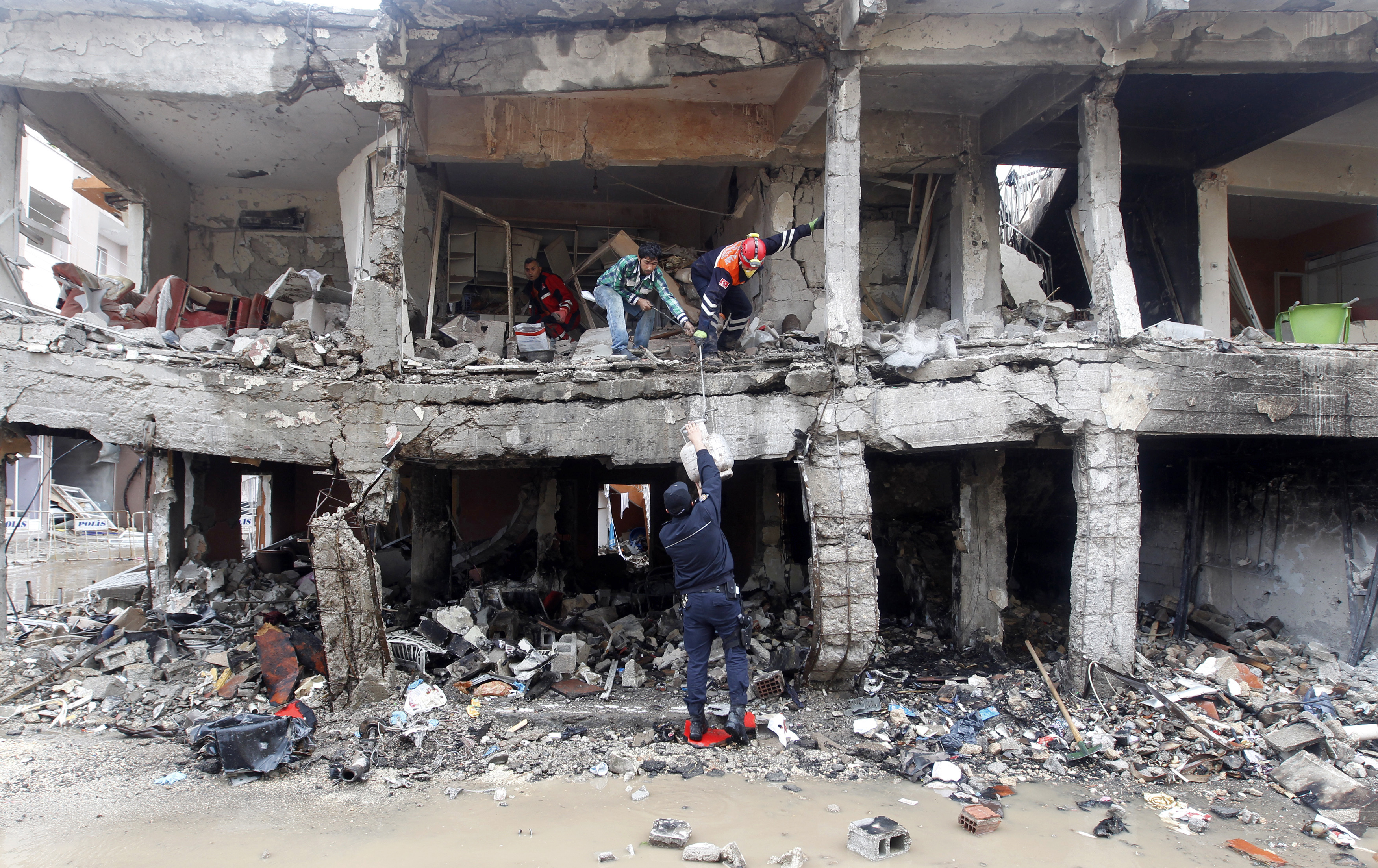 Search and rescue officers work at a damaged building at the site of blast in the town of Reyhanli