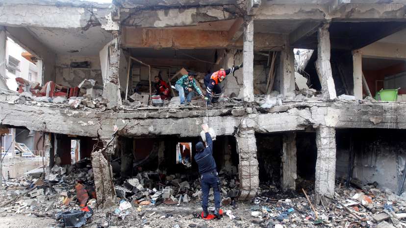 Search and rescue officers work at a damaged building at the site of blast in the town of Reyhanli