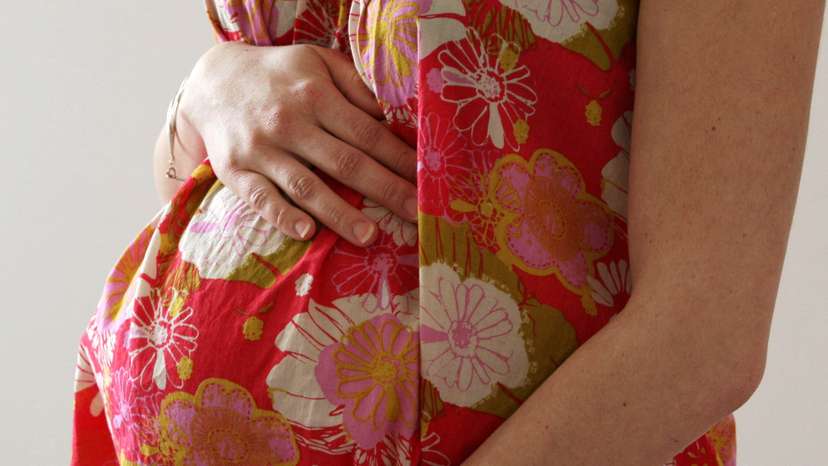 FILE PHOTO: A woman holds her stomach at the last stages of her pregnancy in Bordeaux