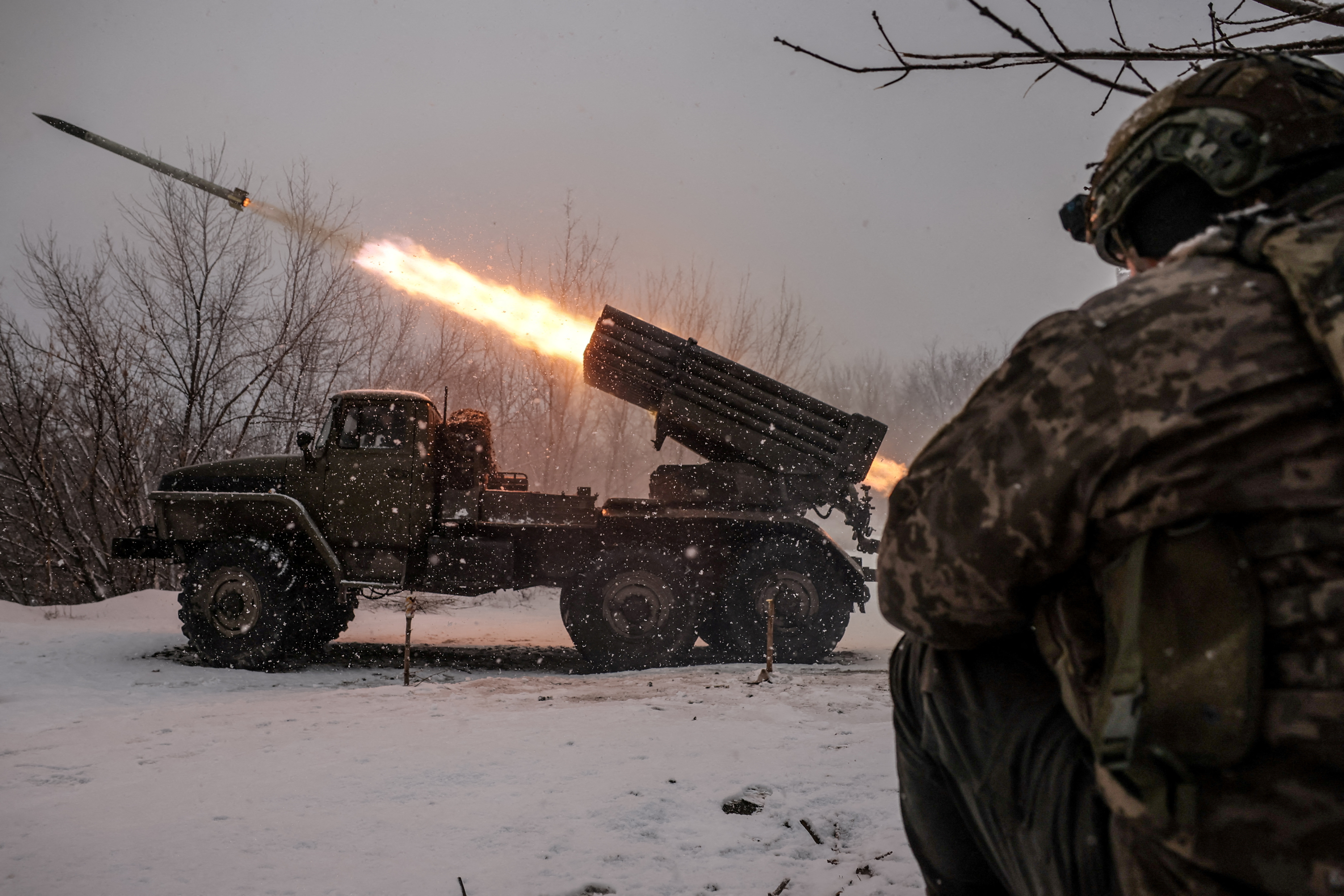 Ukrainian servicemen fire a BM-21 Grad multiple-launch rocket system toward Russian troops on a front line near the town of Chasiv Yar