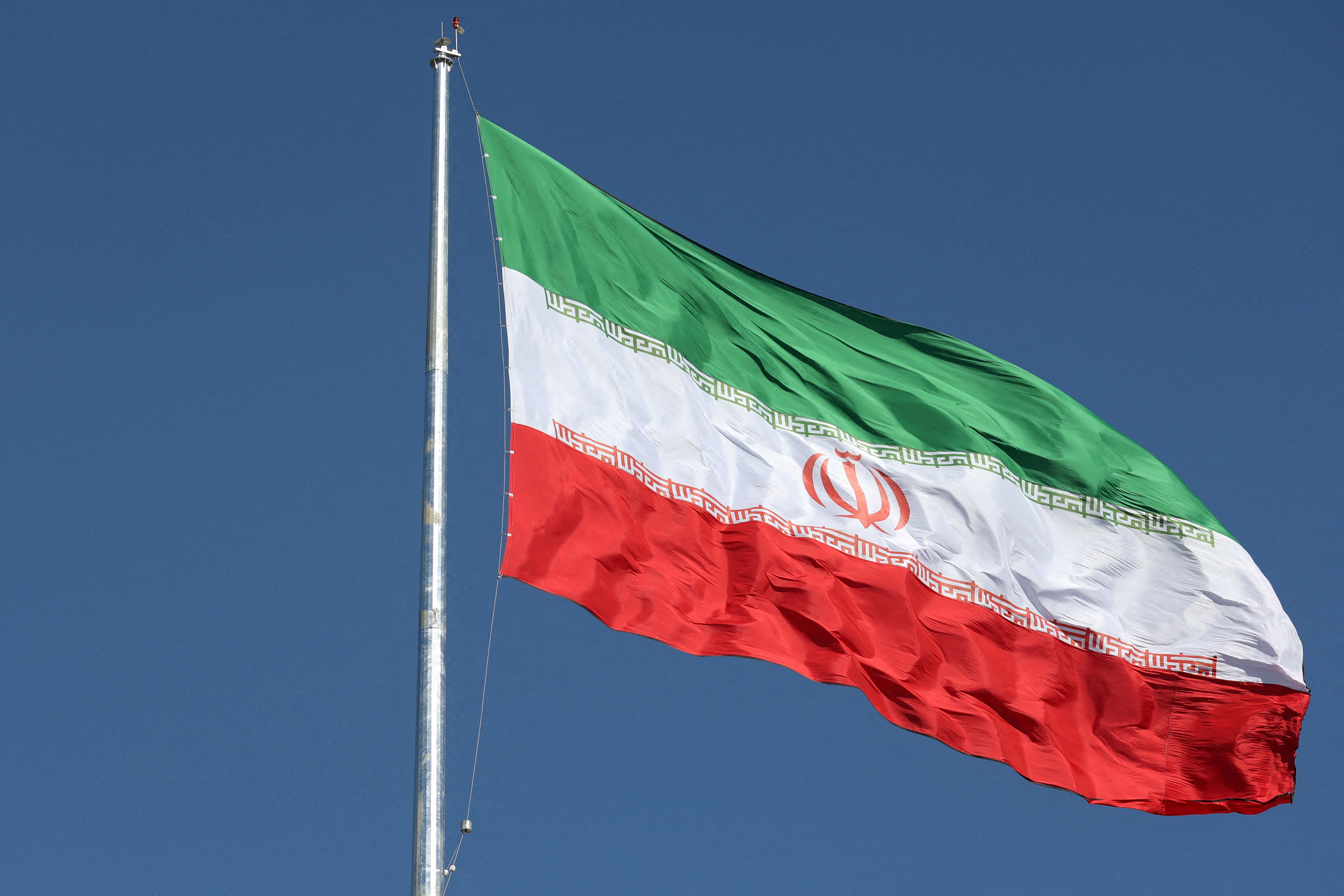 FILE PHOTO: The Iranian flag is seen flying over a street in Tehran