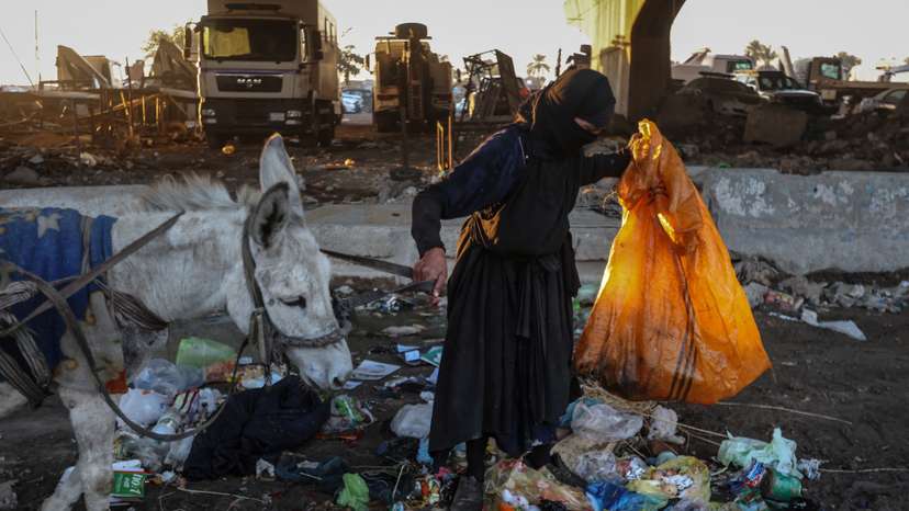 Picking through Baghdad's garbage for her family's Ramadan meal, faith keeps one woman going