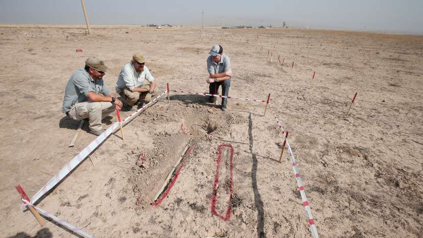 FILE PHOTO: Members of Norwegian People's Aid search for mines and explosive devices east of Mosul
