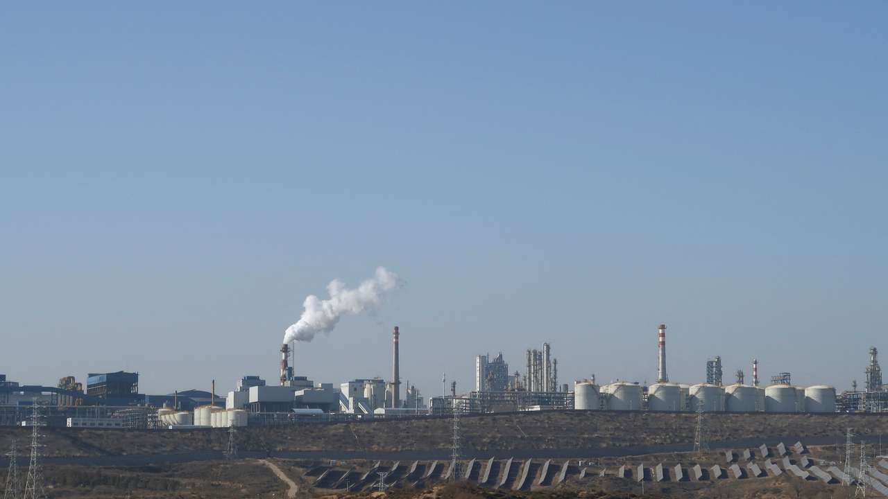 Solar panels lie in front of factories at Jinjie Industrial Park in Shenmu