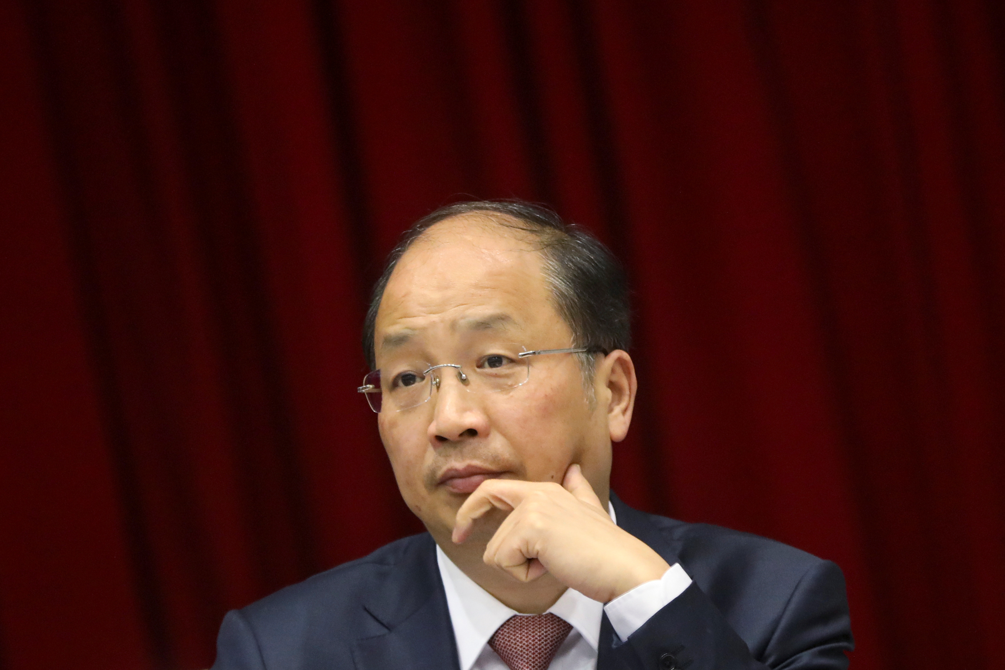 Yi Huiman, chairman of China Securities Regulatory Commission, attends a meeting of Fujian delegation on the sidelines of the National People's Congress (NPC), at the Great Hall of the People in Beijing
