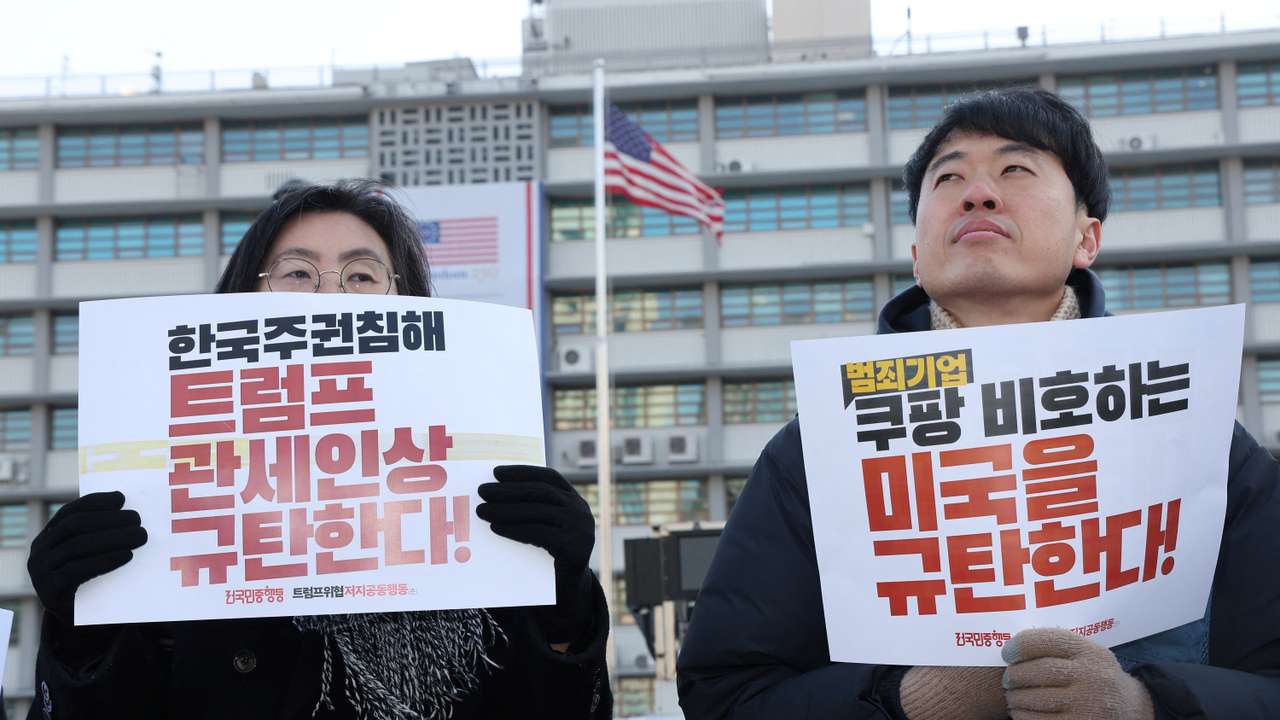 Activists hold signs during an anti-Trump rally in front of the U.S. embassy in Seoul