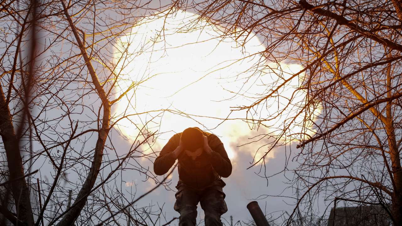 A Ukrainian serviceman fires a 120-mm mortar towards Russian troops at a frontline near the town of Vovchansk