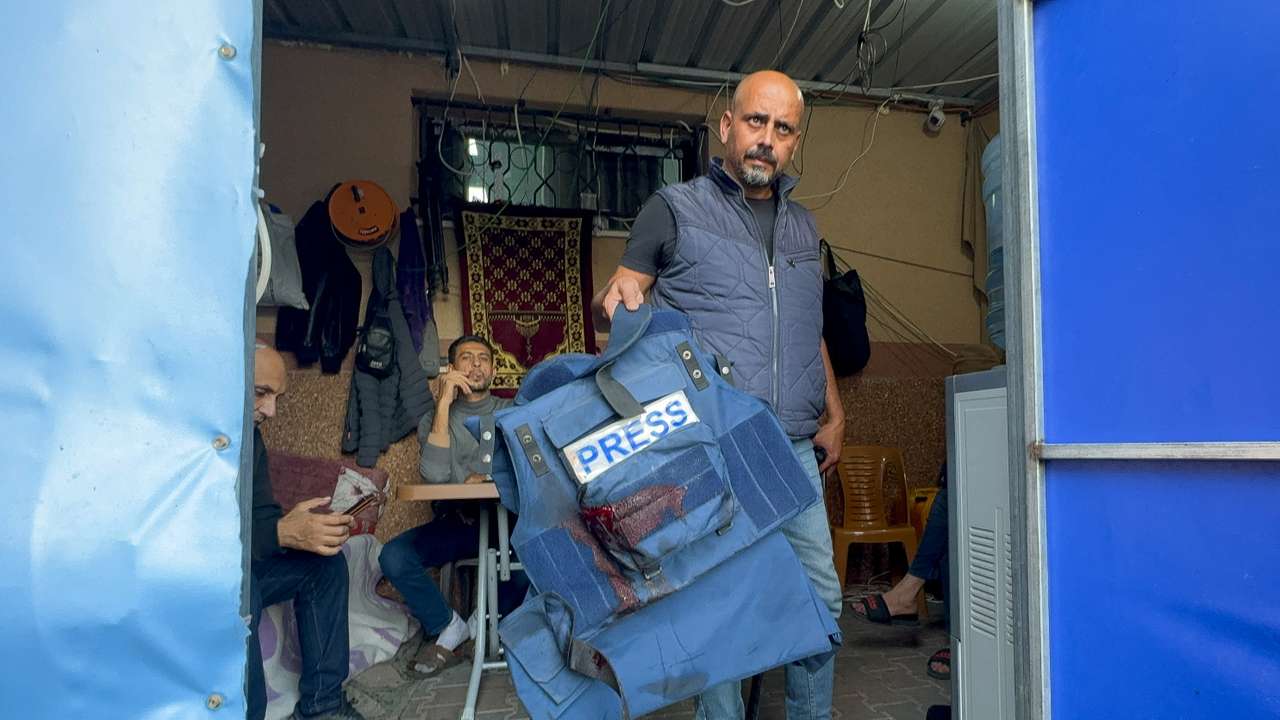 A man holds the flak jacket which belongs to Al Jazeera journalist Wael Al-Dahdouh, in Khan Younis