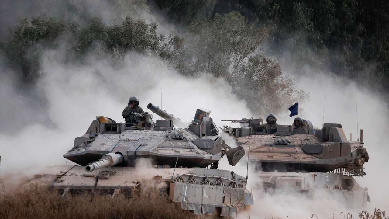 Israeli tanks manoeuvre near the border after entering Israel from Gaza, amid the Israel-Hamas conflict