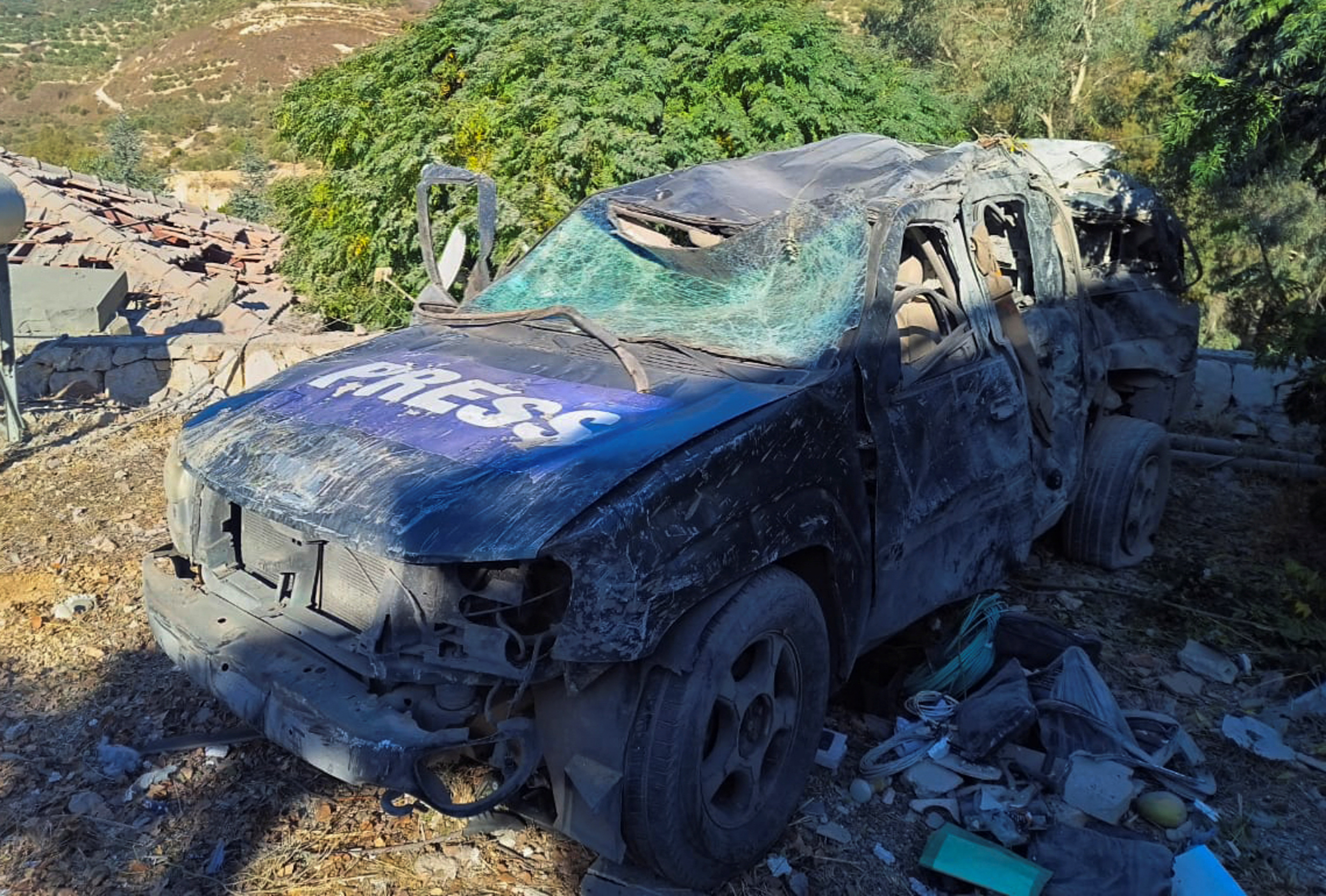 A view shows a damaged Press vehicle in Hasbaya