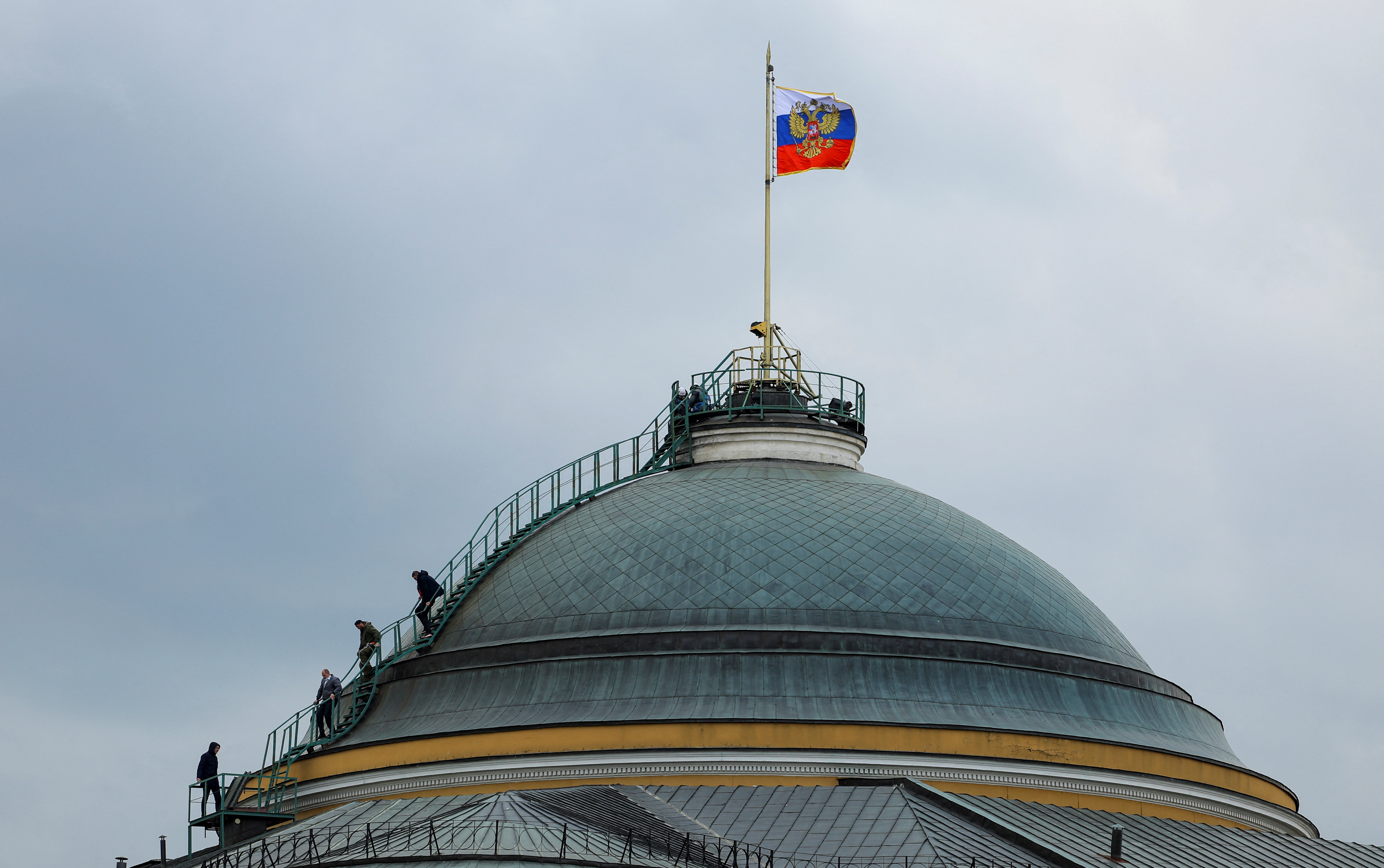 People gather on the dome of the Kremlin Senate building in central Moscow