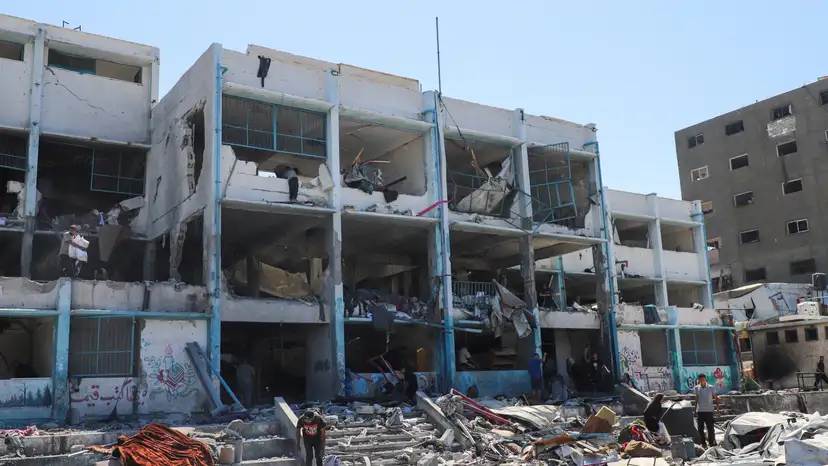 Palestinians inspect the site of evacuated UNRWA school following Israeli strikes, at al-Shati (Beach) refugee camp, in Gaza City