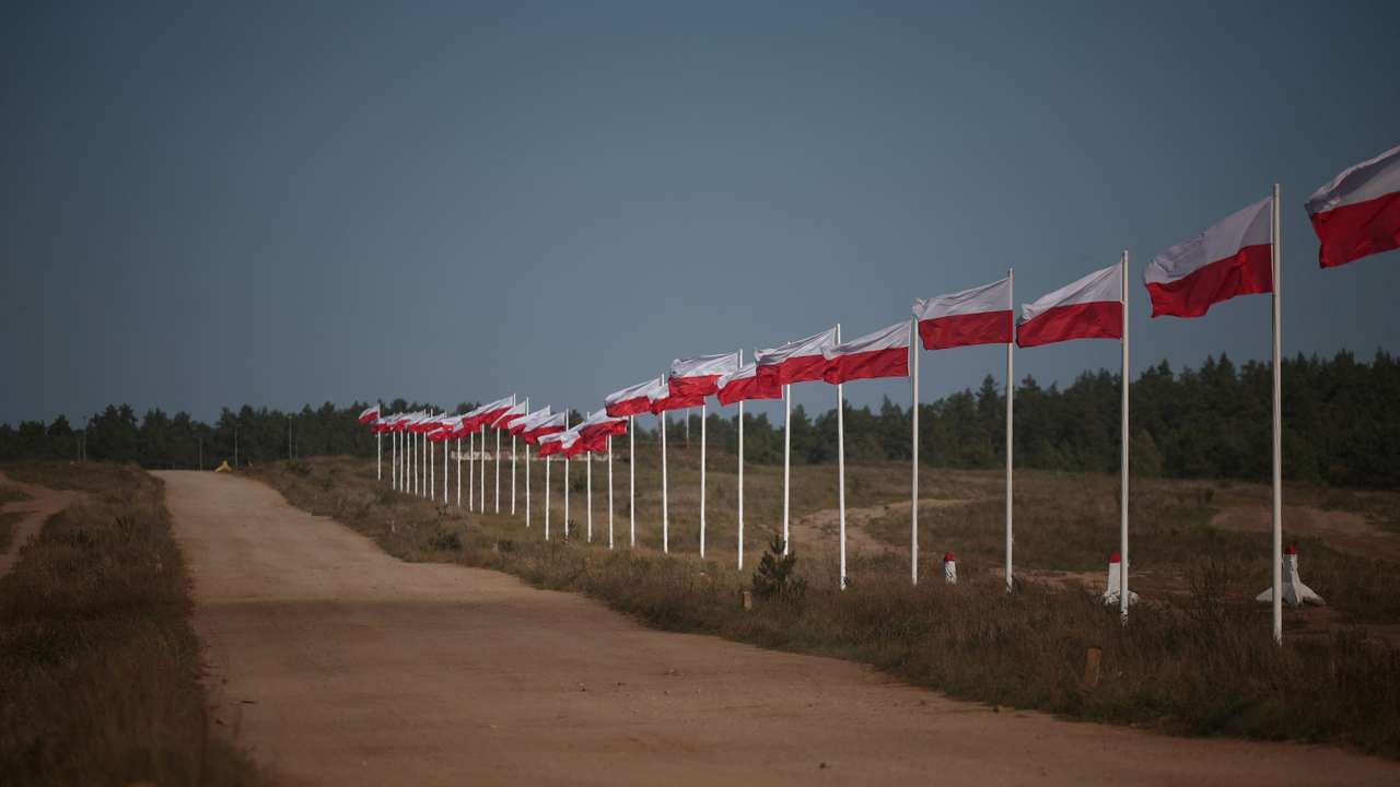 FILE PHOTO: The row of masts with Polish national flags is seen in Bemowo Piskie near Orzysz, Poland