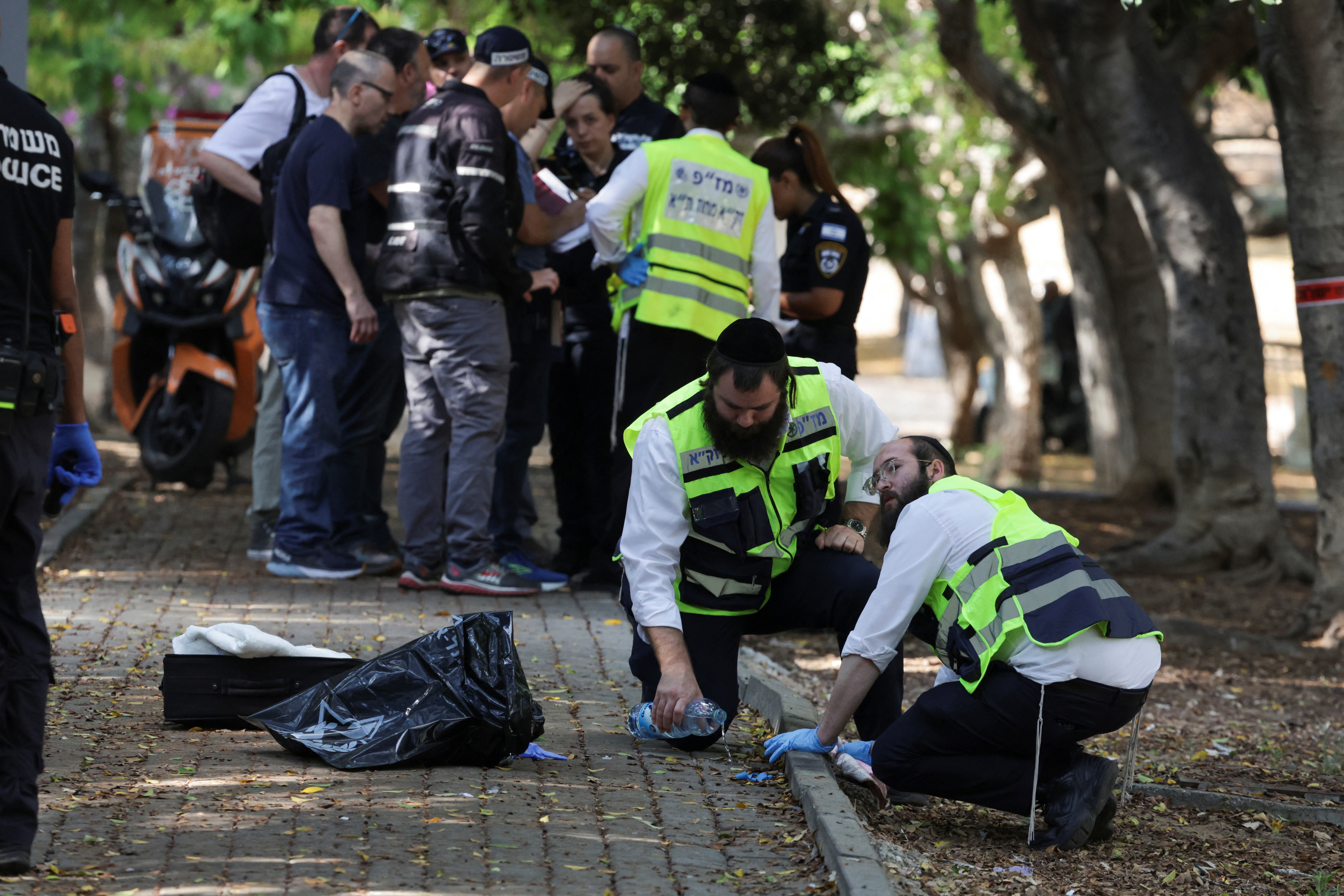 Israeli emergency responders work at the scene of a suspected stabbing attack in Holon
