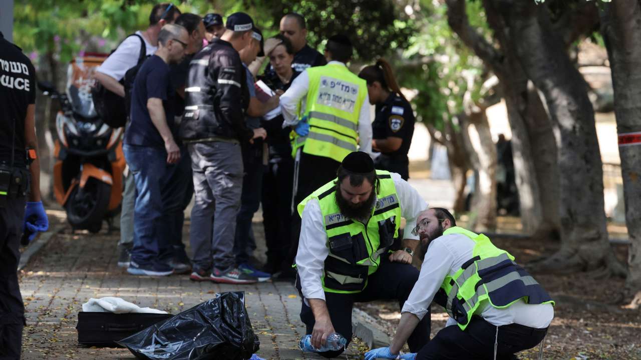Israeli emergency responders work at the scene of a suspected stabbing attack in Holon