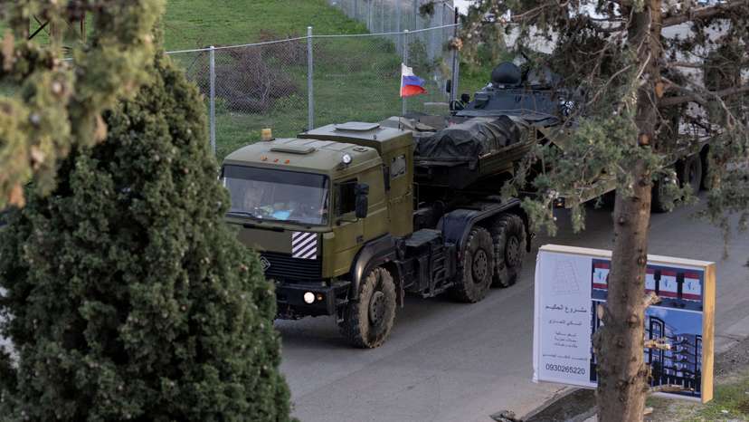 FILE PHOTO: A Russian military vehicle heads towards Hmeimim air base in Syria's coastal Latakia