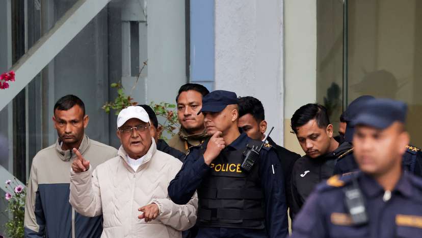 Former Nepal Prime Minister and Chairman of the Communist Party of Nepal, K.P. Sharma Oli gestures while being taken to a hospital from the District Police Range after his detention by police, in Kathmandu