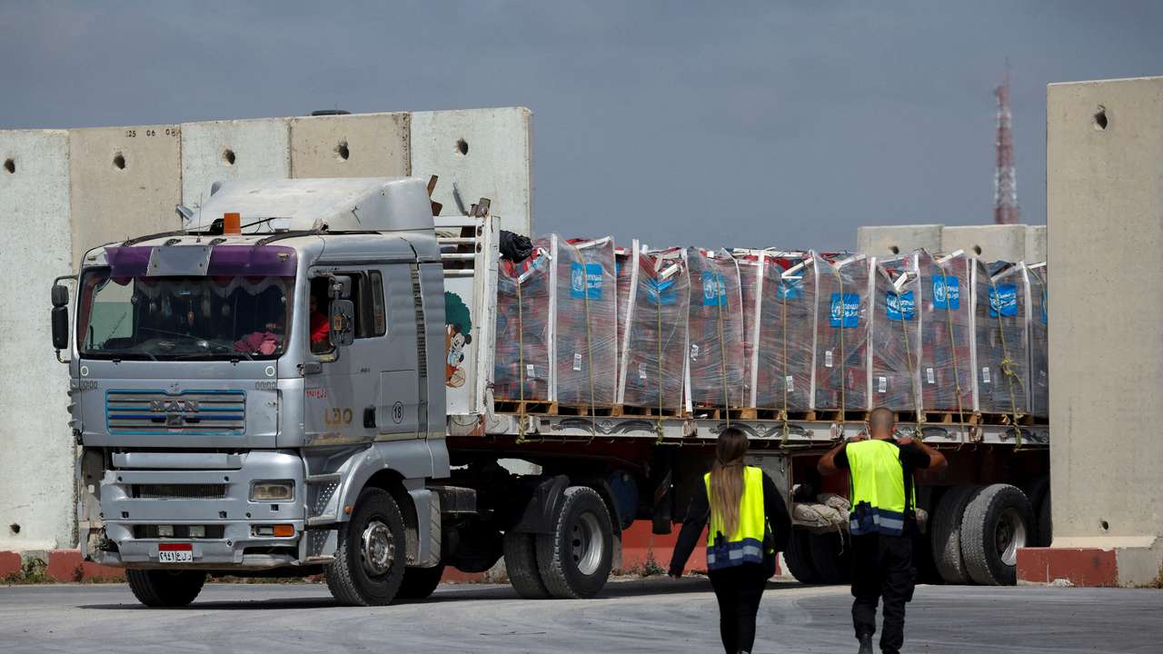 A truck carrying humanitarian aid bound for the Gaza Strip drives at the inspection area at the Kerem Shalom crossing