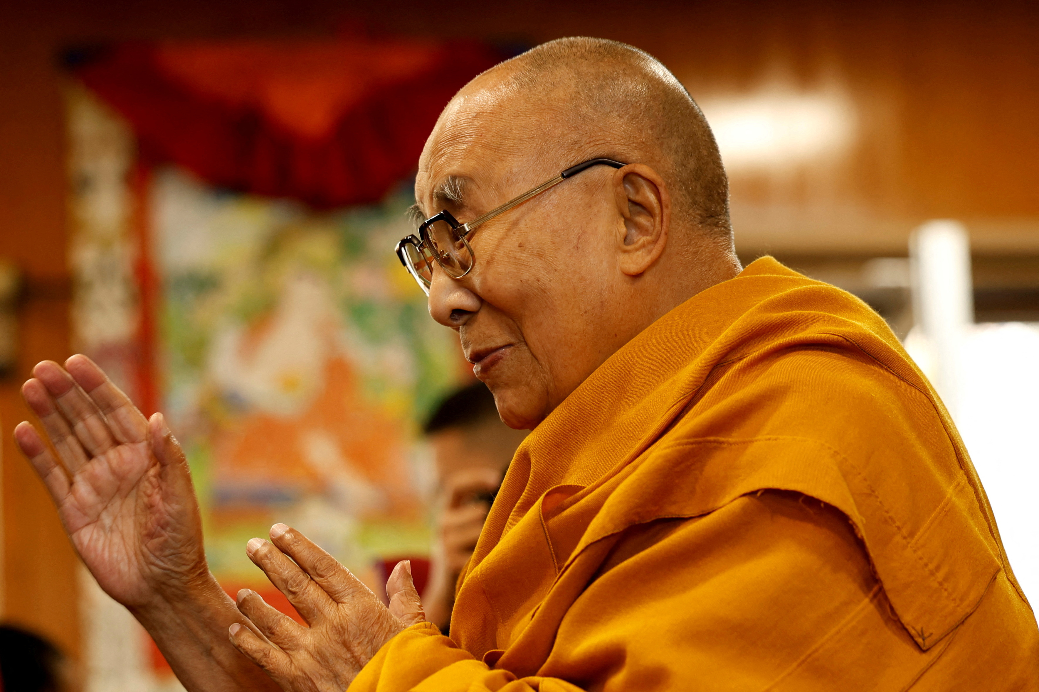 FILE PHOTO: Tibetan spiritual leader, the Dalai Lama, offers blessings to his followers at his Himalayan residence in Dharamshala