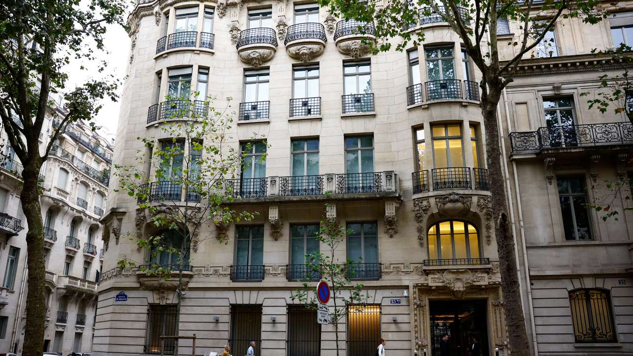 People walk past the Rothschild & Co headquarters in Paris
