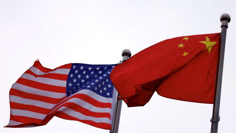 FILE PHOTO: Chinese and U.S. flags flutter outside the building of an American company in Beijing