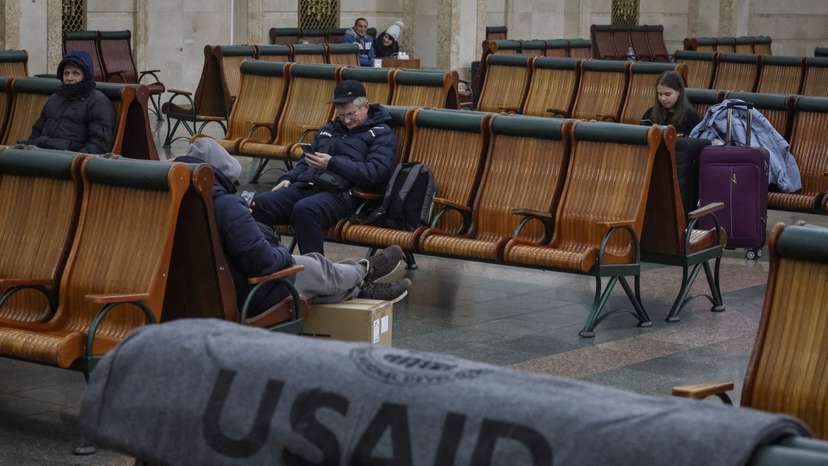 FILE PHOTO: Passengers rest in the waiting room as one of the blankets donated by the USAID is seen, in Kyiv