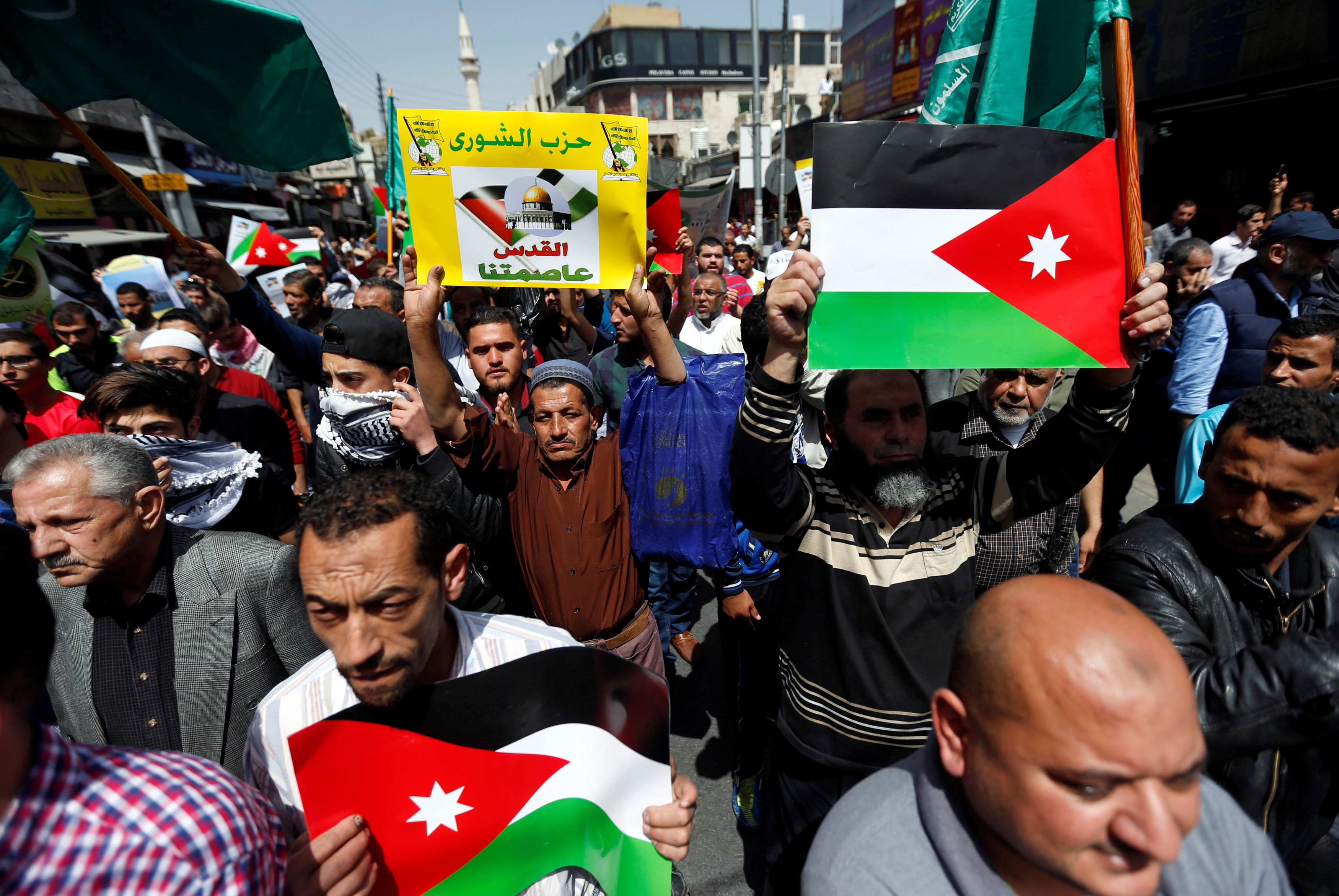Supporters of the Muslim Brotherhood hold Jordanian flags and chant slogans during a pro-Palestinian demonstration after Friday prayers in Amman