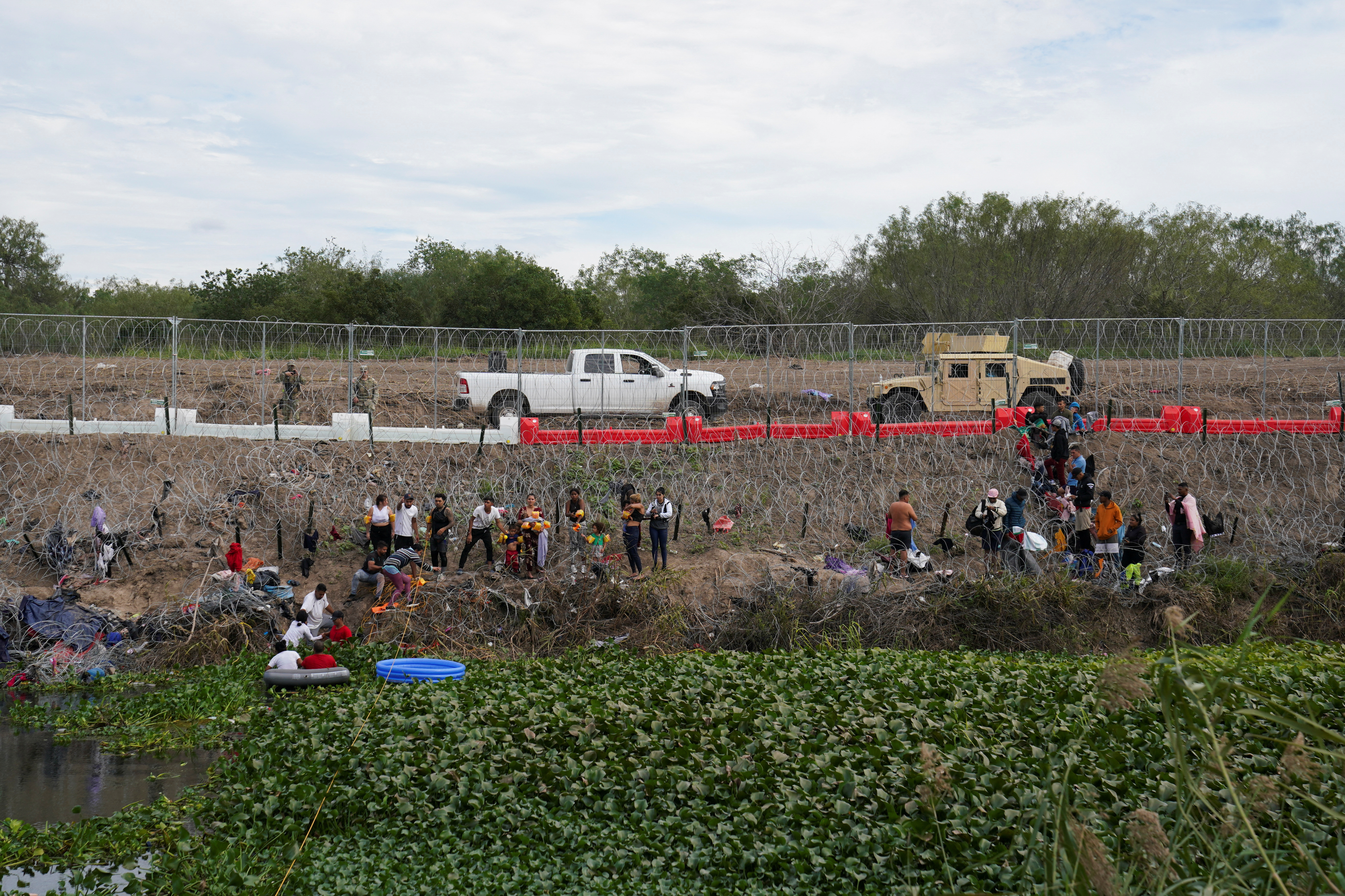 Migrants cross the Rio Grande river in Matamoros