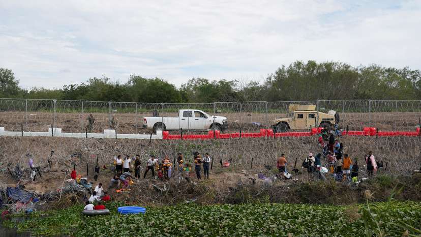 Migrants cross the Rio Grande river in Matamoros