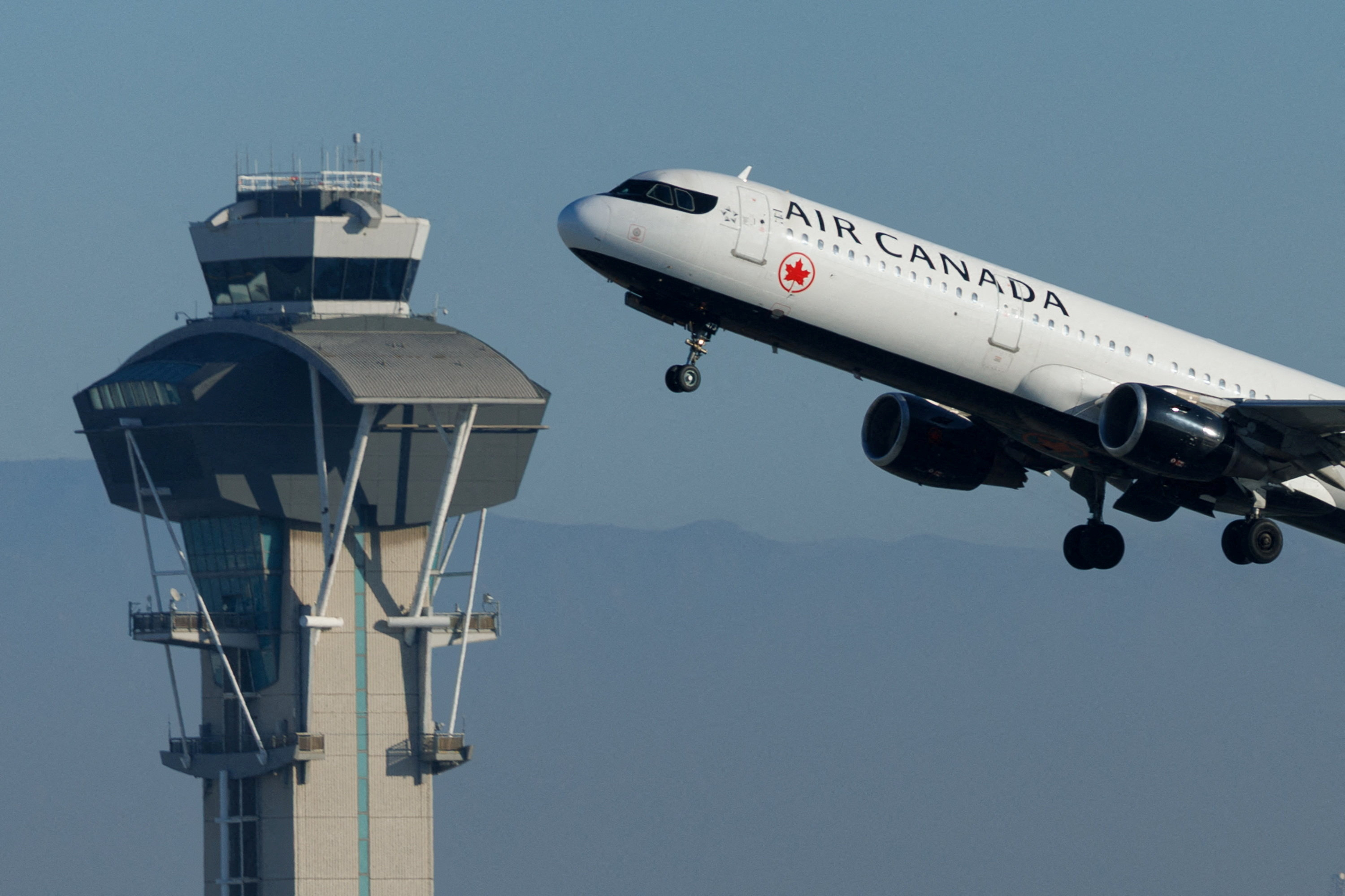 FILE PHOTO: Commercial airliners take-off from Los Angeles International Airport