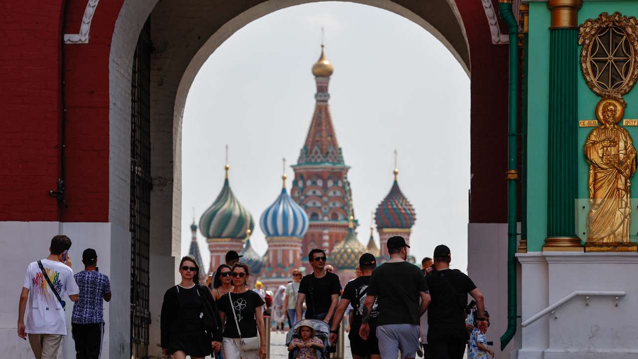 People walk near the Red Square in Moscow