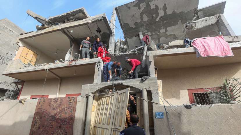 Palestinians inspect the site of an Israeli strike on a house, in Rafah, in the southern Gaza Strip