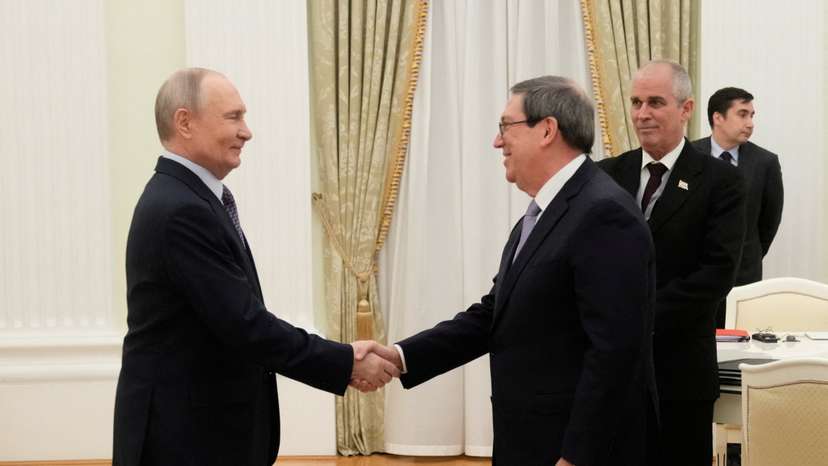 Russian President Vladimir Putin and Cuban Foreign Minister Bruno Rodriguez Parrilla attend a meeting at the Senate Palace of the Kremlin in Moscow