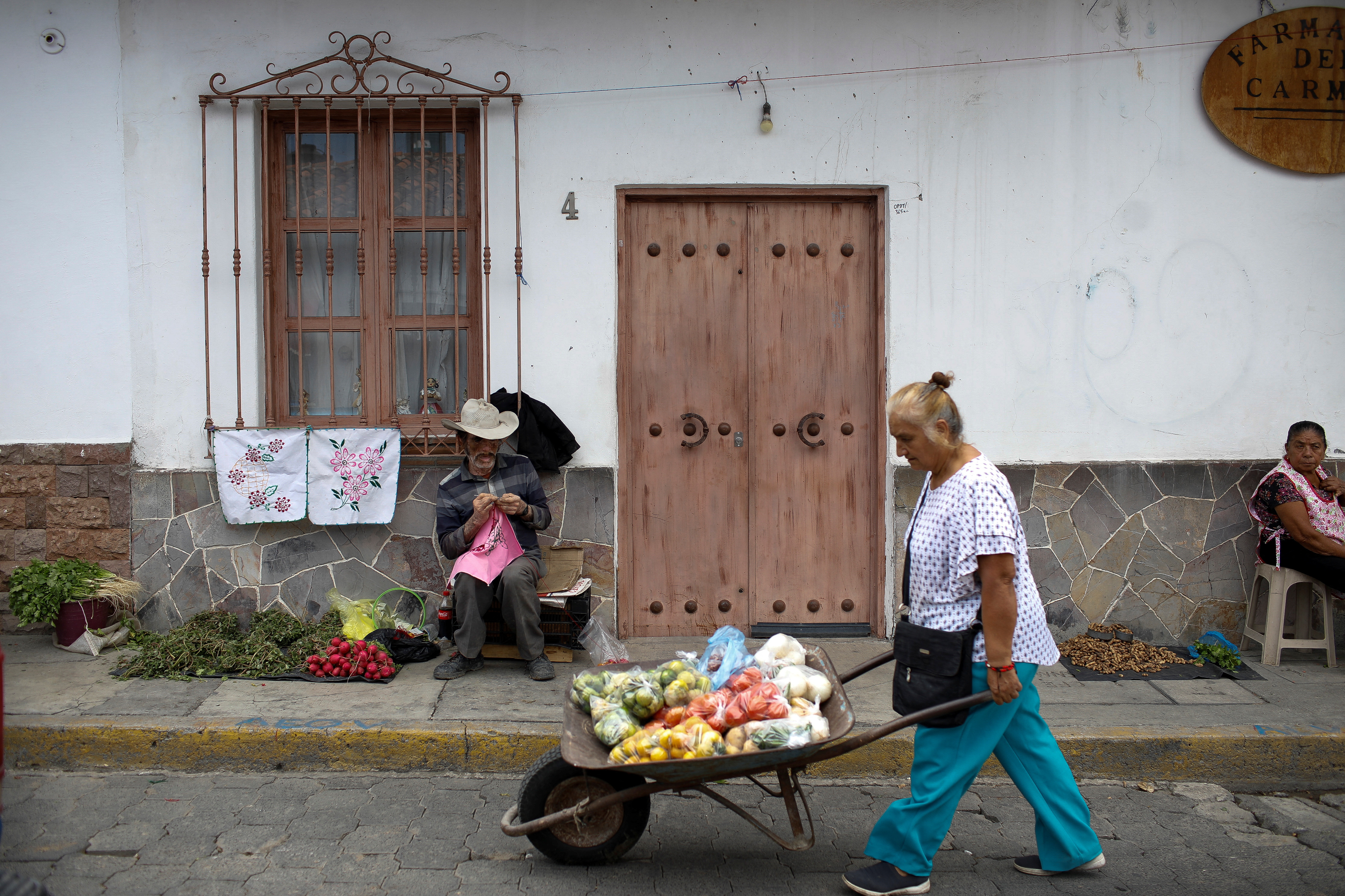 People sell fruits and vegetables in the downtown of Tonatico
