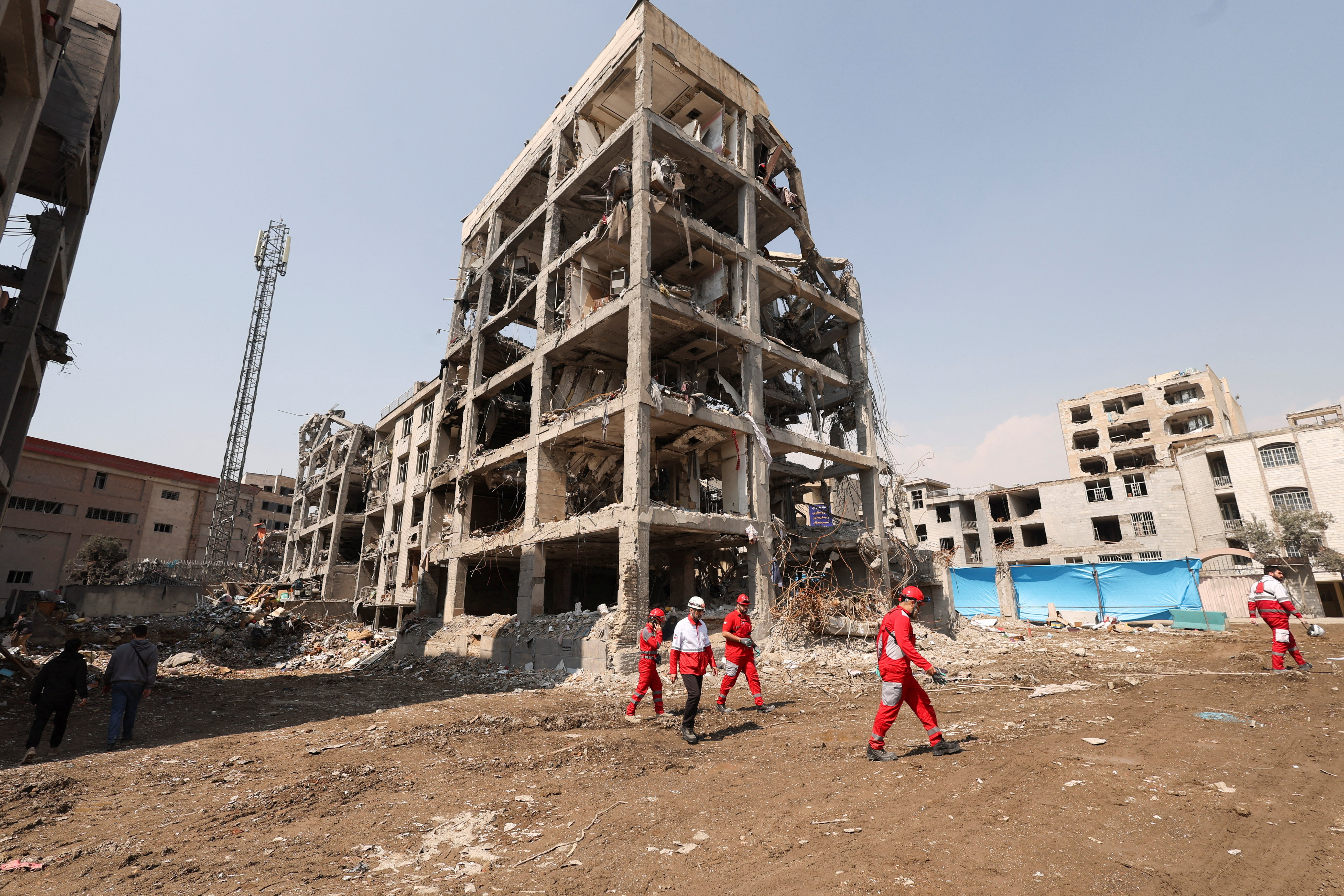 Red Crescent rescue team works next to a building that was damaged by a strike