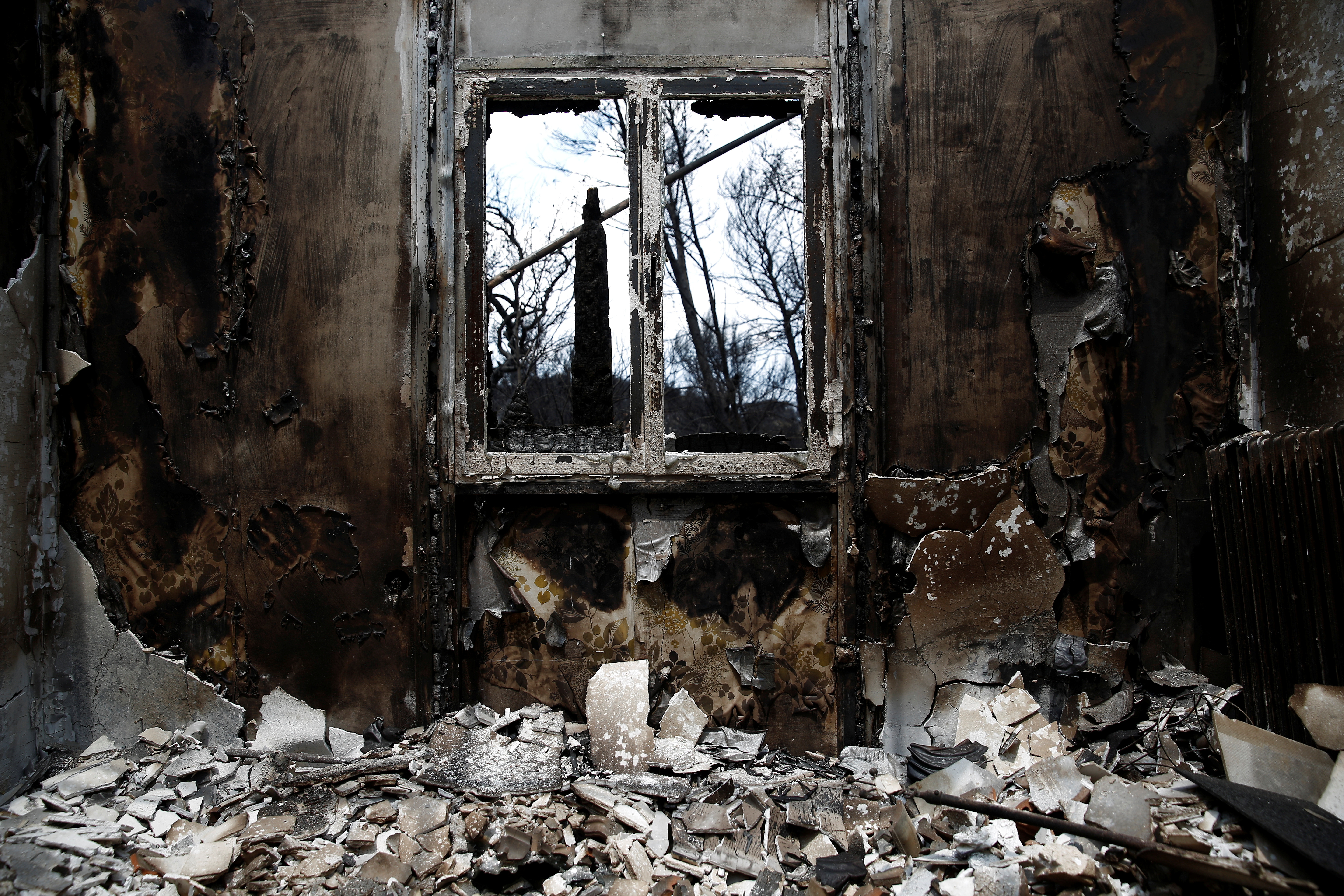The interior of a burnt house is seen following a wildfire in the village of Mati, near Athens