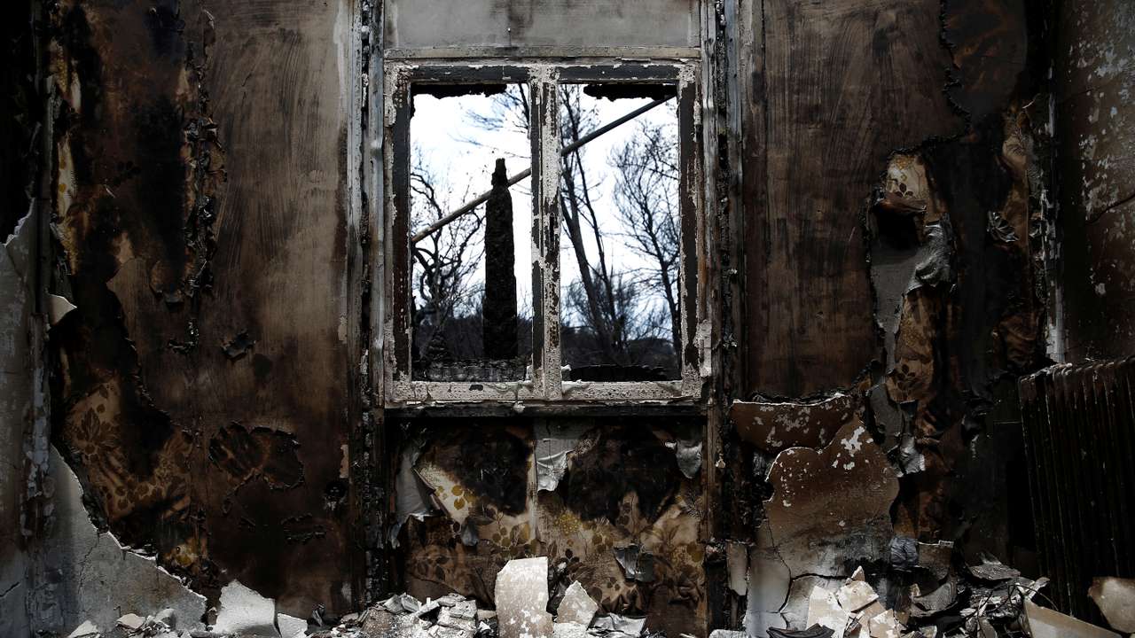 The interior of a burnt house is seen following a wildfire in the village of Mati, near Athens