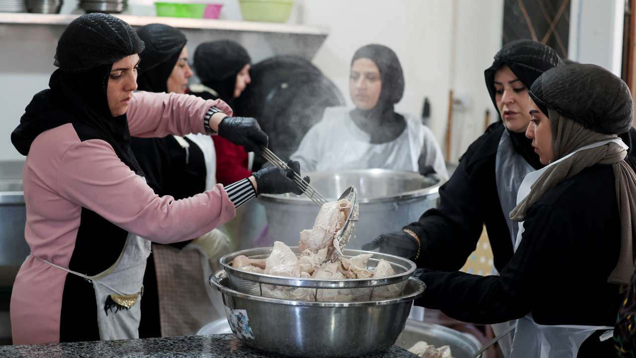 Women from Southern Lebanon prepare meals as they work in a community kitchen in Tyre